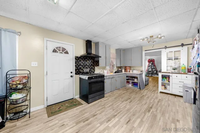 a kitchen with stainless steel appliances kitchen island granite countertop a refrigerator and a stove top oven