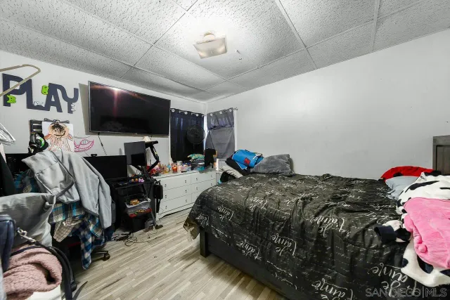 a bedroom with bed and a flat tv screen