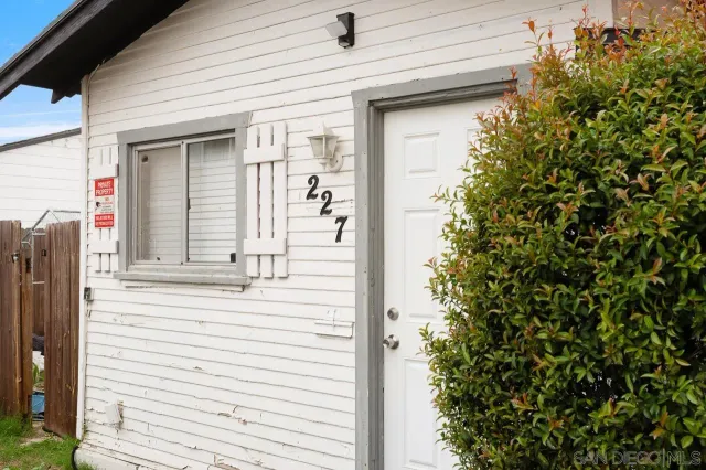 a view of a house with a door and wooden walls