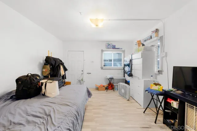 a bedroom with furniture and a flat screen tv