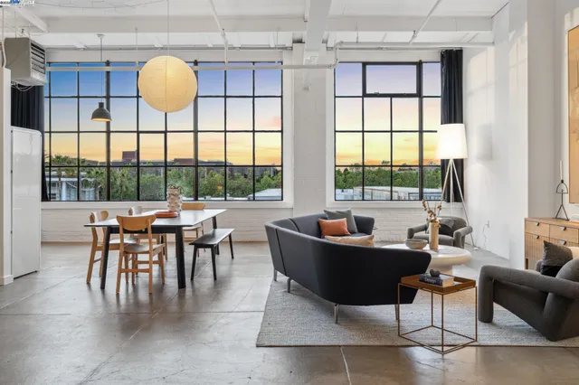 a living room with furniture a window and a table