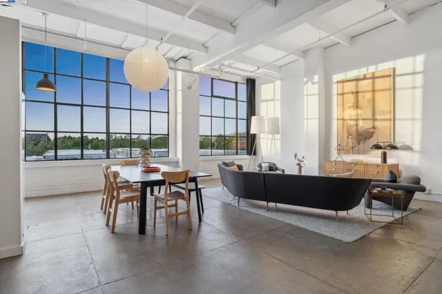 a view of a dining room with furniture and a large window