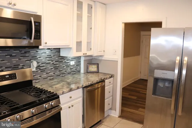 a kitchen with granite countertop cabinets and steel stainless steel appliances