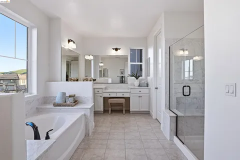 a bathroom with a double vanity sink mirror and shower