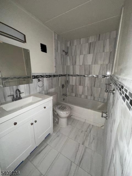 77 Prospect Avenue, Unit H Hackensack, NJ 07601 - Photo 4 of 17 a bathroom with a double vanity sink toilet and shower