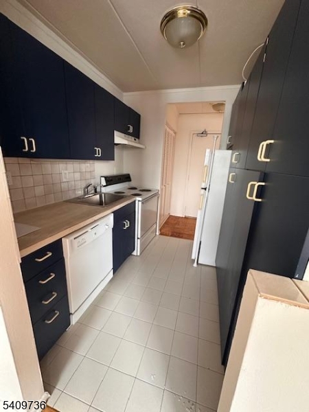 77 Prospect Avenue, Unit H Hackensack, NJ 07601 - Photo 7 of 17 a kitchen with a sink a stove top oven and cabinets