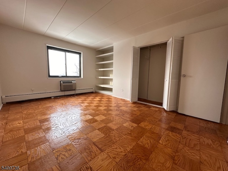 77 Prospect Avenue, Unit H Hackensack, NJ 07601 - Photo 8 of 17 an empty room with windows