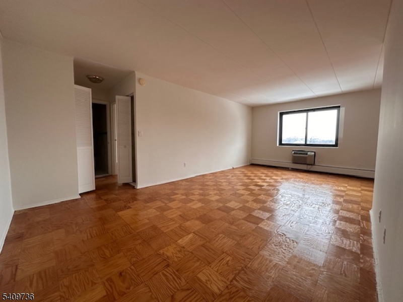 77 Prospect Avenue, Unit H Hackensack, NJ 07601 - Photo 9 of 17 a view of empty room with wooden floor