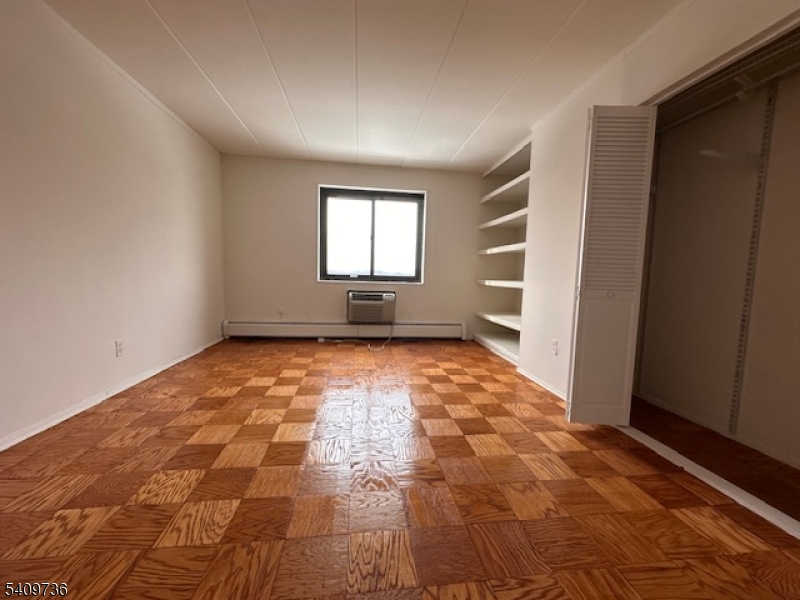 77 Prospect Avenue, Unit H Hackensack, NJ 07601 - Photo 10 of 17 a view of an empty room and window