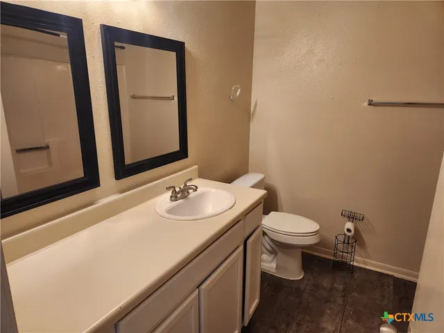 a bathroom with a sink a toilet and mirror