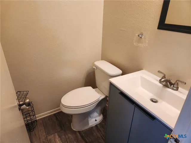 a bathroom with a sink toilet and a mirror
