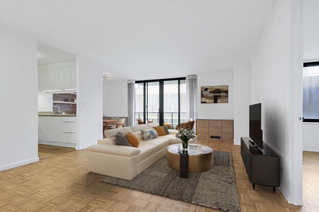 161 West 61st Street, Unit 15E Manhattan, NY 10023 - Photo 4 of 24 a living room with furniture a rug and a flat screen tv