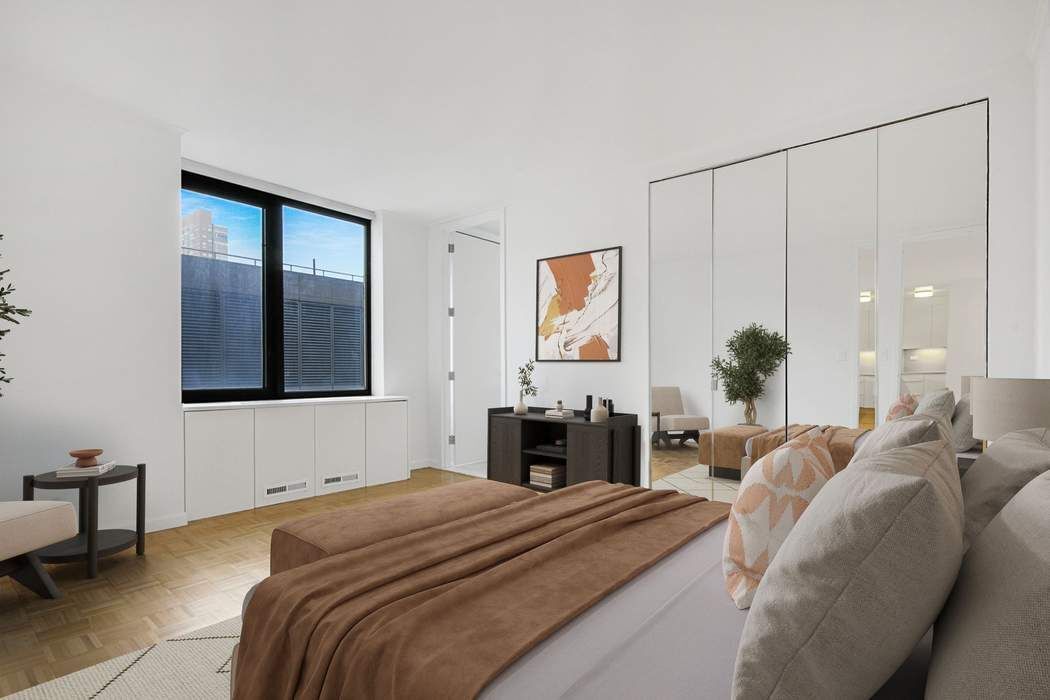 161 West 61st Street, Unit 15E Manhattan, NY 10023 - Photo 5 of 24 a bedroom with a bed and a chandelier