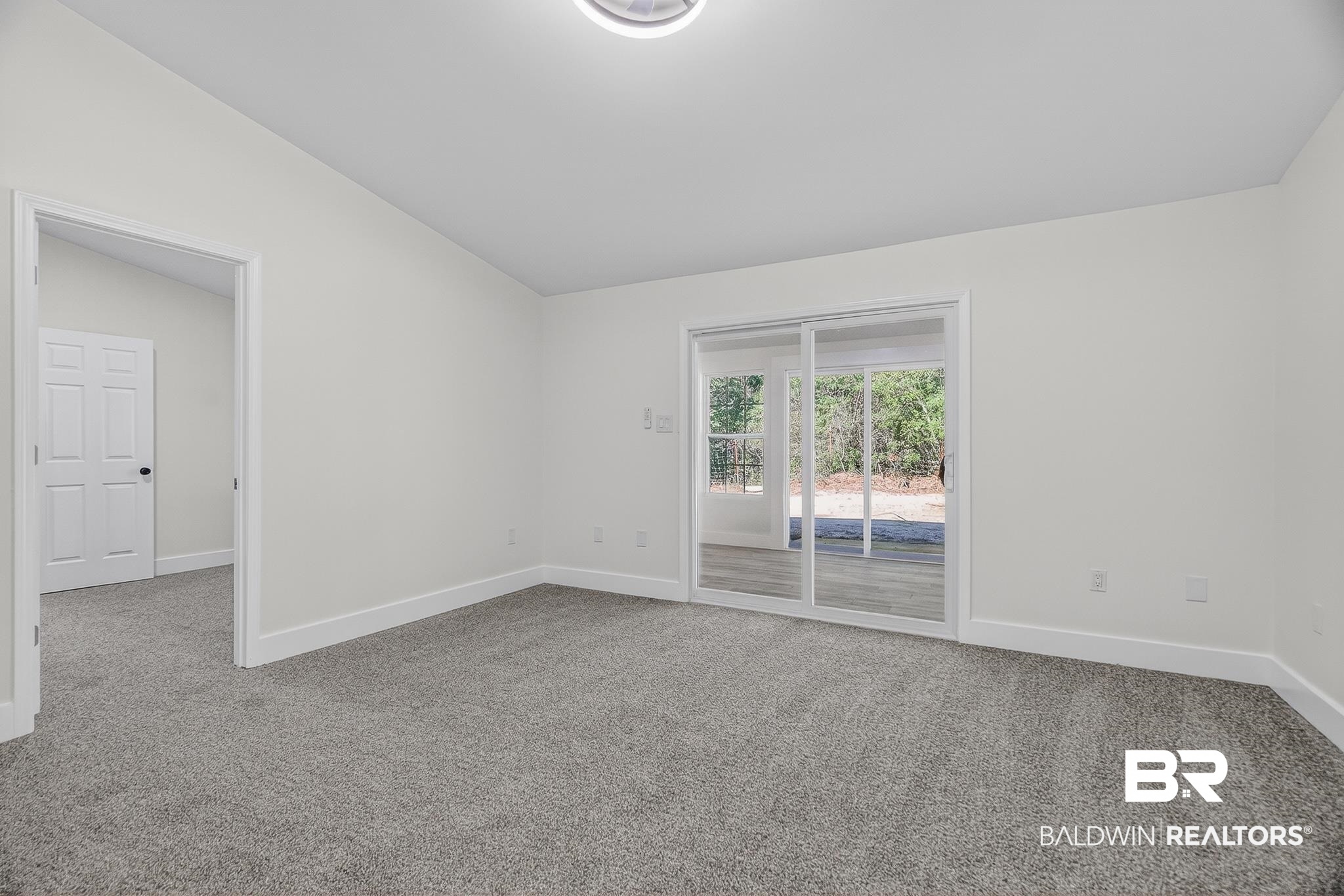 10650 Old Pascagoula Road Theodore, AL 36582 - Photo 62 of 77 Spare room with lofted ceiling and light colored carpet