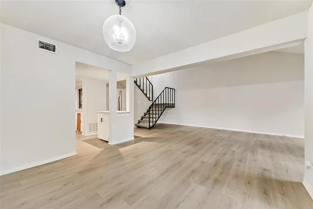 a view of a room with wooden floor and white walls