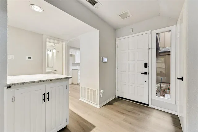 a view of a hallway with front door