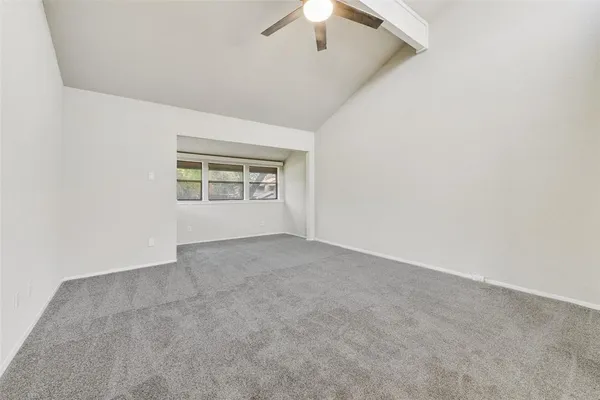 an empty room with a empty space and a ceiling fan