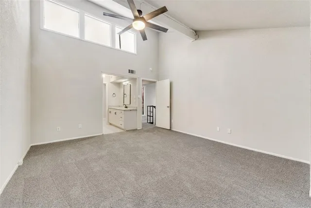 an empty room with a ceiling fan and a ceiling fan