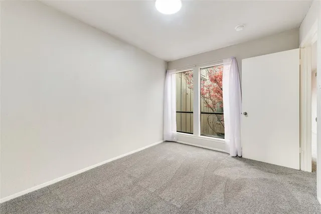 a view of an empty room with glass door