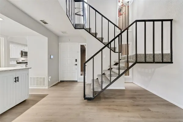 a view of staircase with wooden floor and a sink