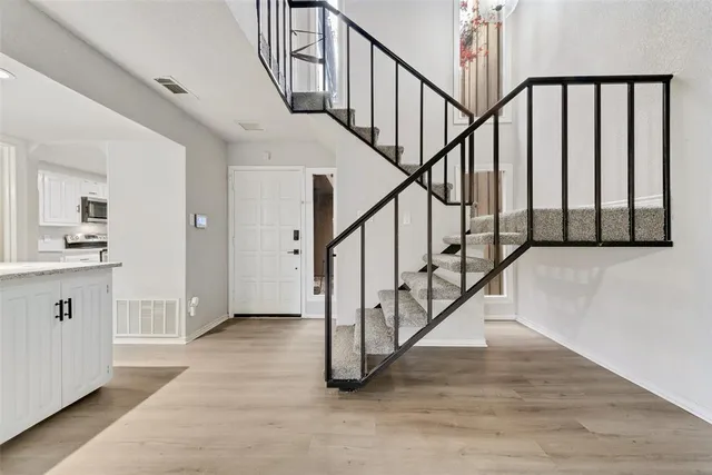 a view of staircase with wooden floor and a sink