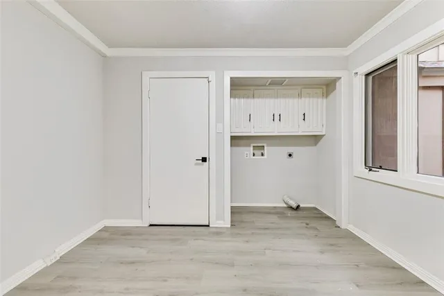 a view of an empty room with closet and window