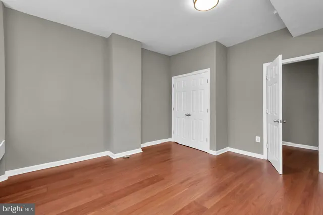a view of a room with wooden floor