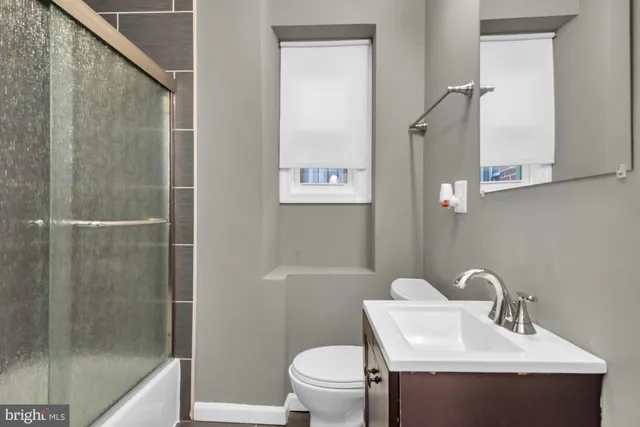 a bathroom with a sink toilet and vanity