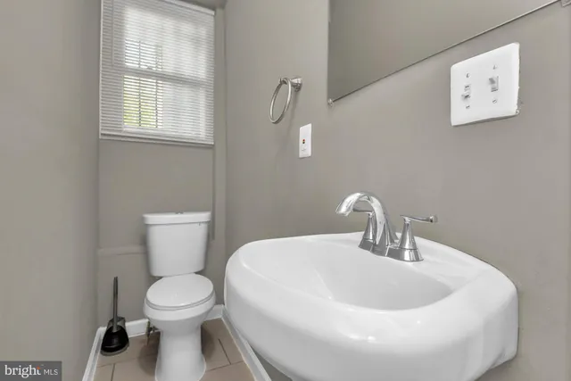 a white toilet sitting next to a bathroom sink