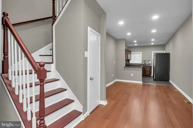 a view of a kitchen with wooden floor and electronic appliances