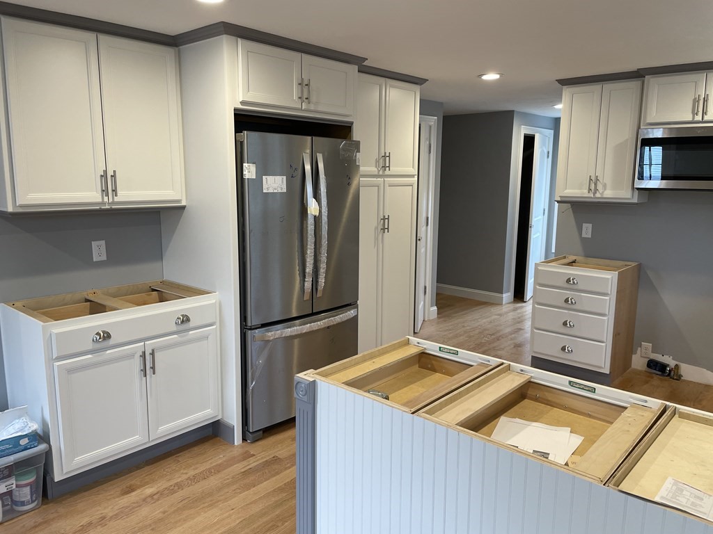 6 Allen Rd Extension Billerica, MA 01821 - Photo 14 of 17 a kitchen with a refrigerator and a stove top oven