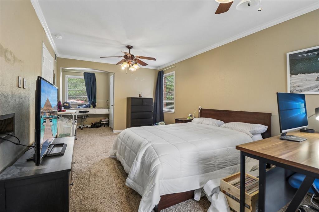 820 North Bowen Road Arlington, TX 76012 - Photo 24 of 40 a spacious bedroom with a bed and a flat screen tv