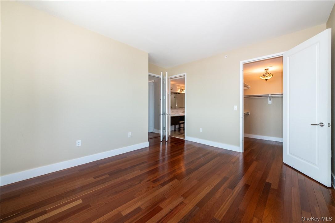 175 Huguenot Street, Unit 1802 New Rochelle, NY 10801 - Photo 17 of 31 a view of an empty room with wooden floor