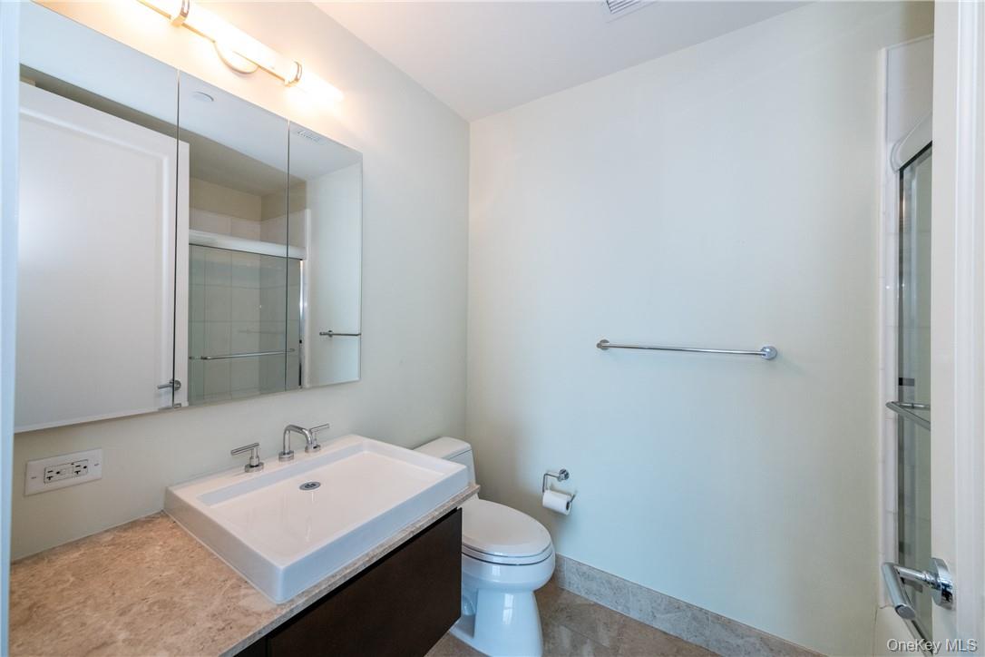 175 Huguenot Street, Unit 1802 New Rochelle, NY 10801 - Photo 22 of 31 a bathroom with a sink toilet and mirror