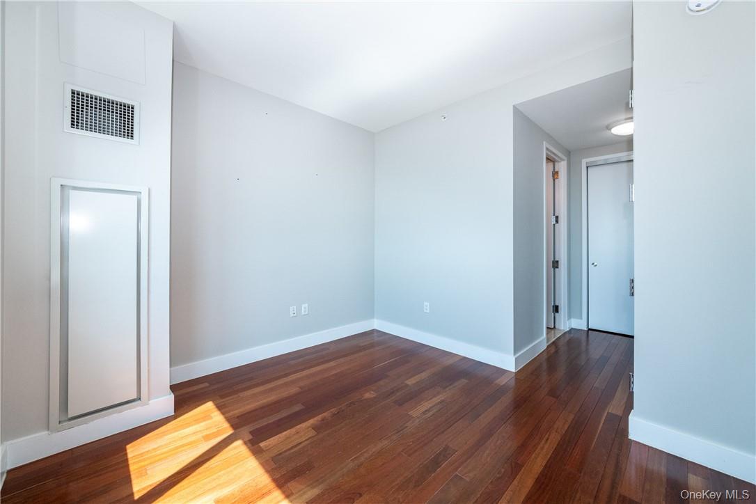 175 Huguenot Street, Unit 1802 New Rochelle, NY 10801 - Photo 23 of 31 a view of a room with wooden floor and closet