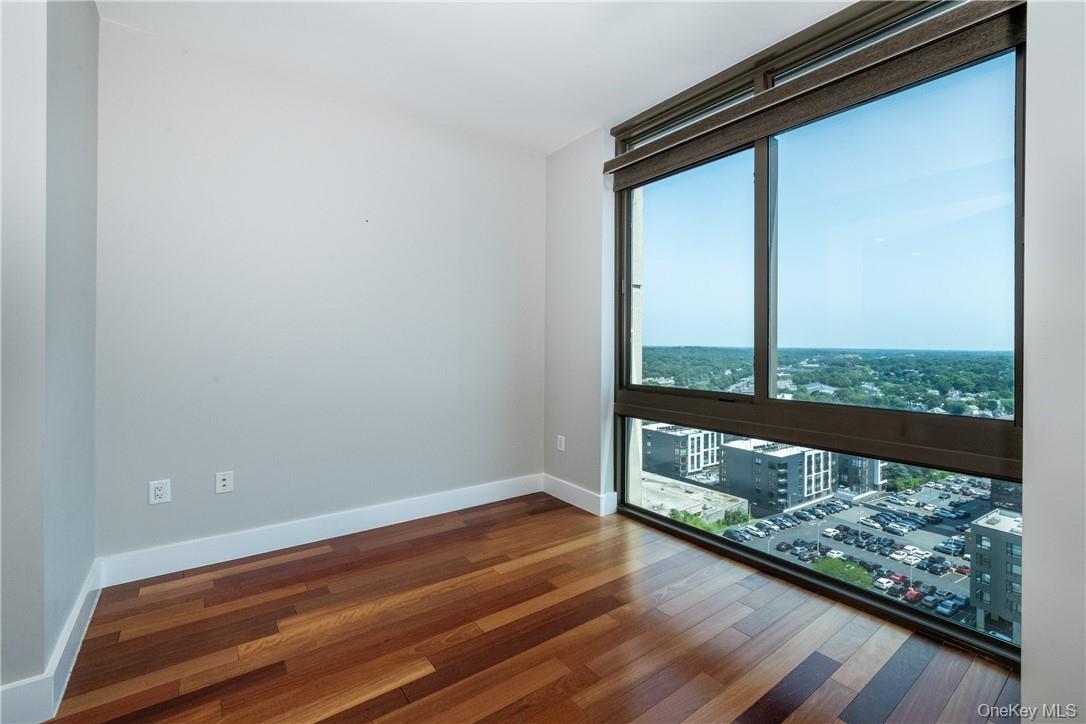 175 Huguenot Street, Unit 1802 New Rochelle, NY 10801 - Photo 4 of 31 a view of a floor to ceiling window with wooden floor