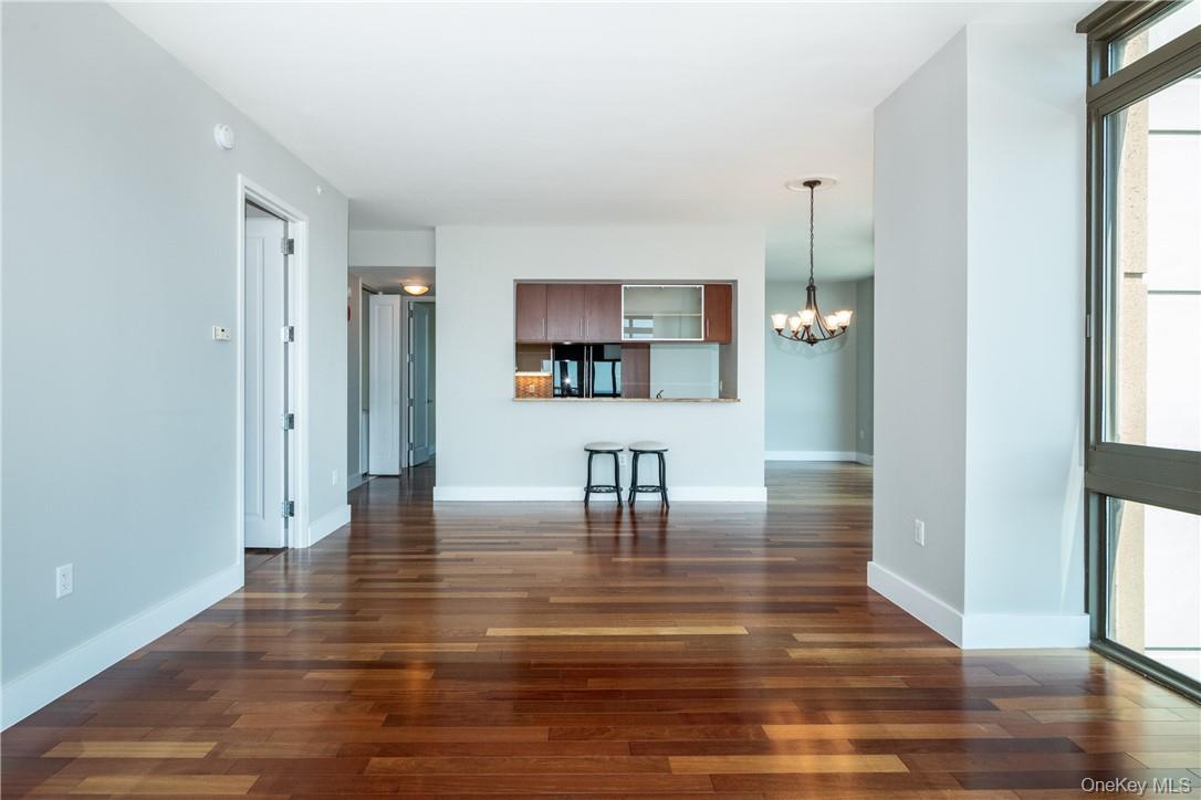 175 Huguenot Street, Unit 1802 New Rochelle, NY 10801 - Photo 8 of 31 a view of dining room with kitchen island stainless steel appliances wooden floor and window