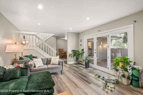 a living room with furniture and a potted plant
