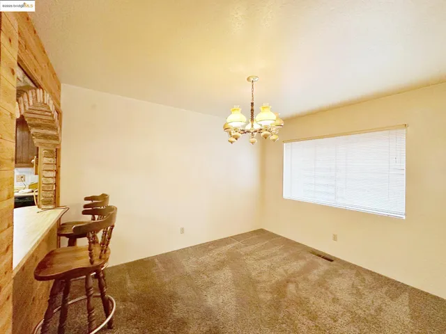 a view of a room with a chandelier and a window