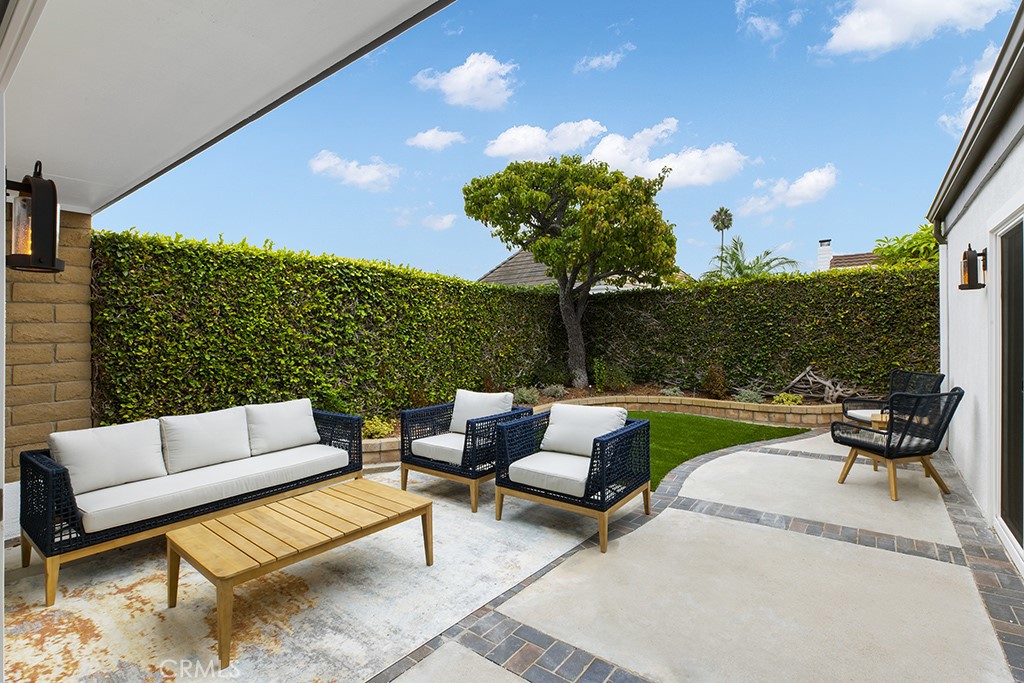 a view of a patio with couches and potted plants