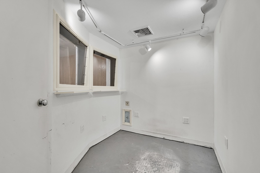 16 Roundwood Road Newton, MA 02464 - Photo 35 of 41 an empty room with a ceiling fan and window