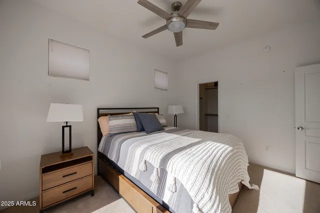 a bedroom with a bed and a night stand