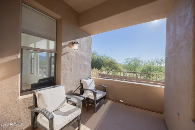 a building outdoor space with patio furniture and potted plants