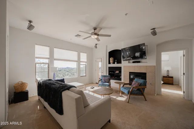 a living room with fireplace furniture and a flat screen tv