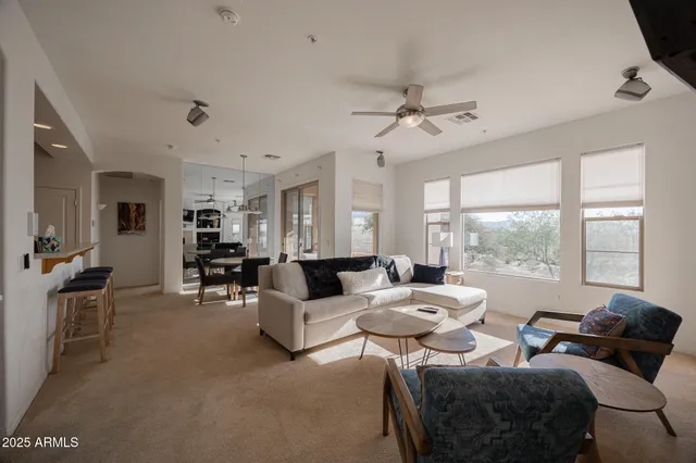 a living room with furniture and a large window