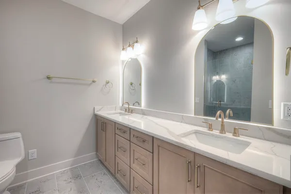 a bathroom with a double vanity sink and a mirror