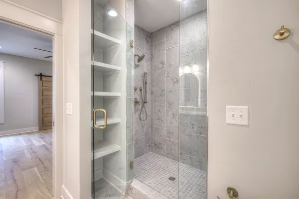 a bathroom with a glass shower door
