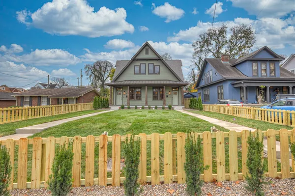 a front view of a residential houses with yard
