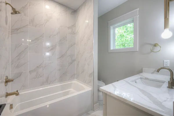 a bathroom with a sink a toilet and bathtub
