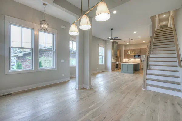 a view of a room with wooden floor and windows